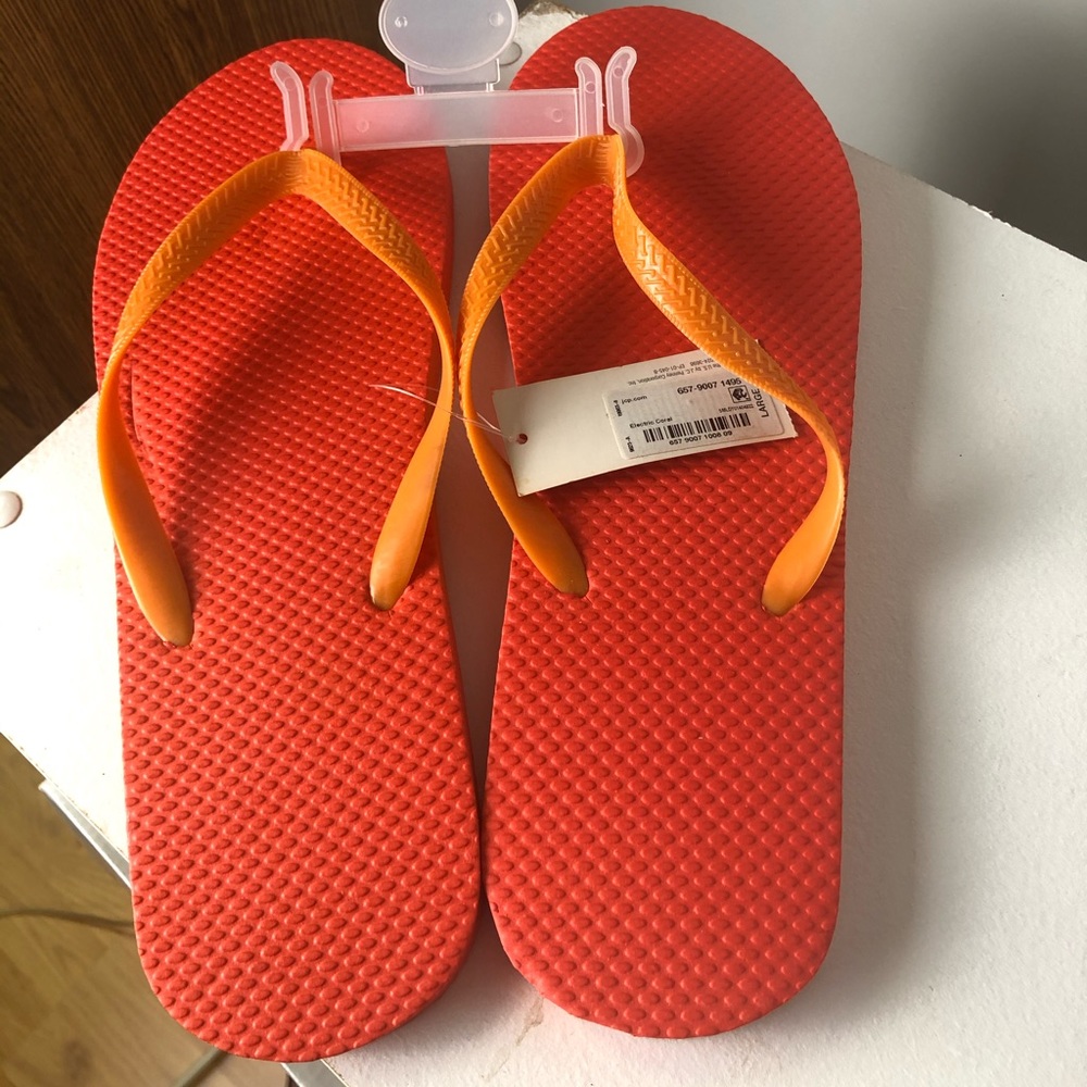 Size 10/11 men’s coral flip flops brand new